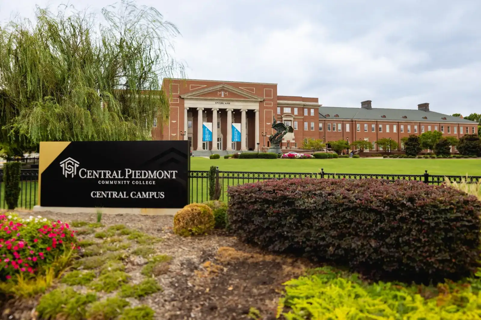 Central Piedmont monument sign at the Central Campus entrance beside a willow tree