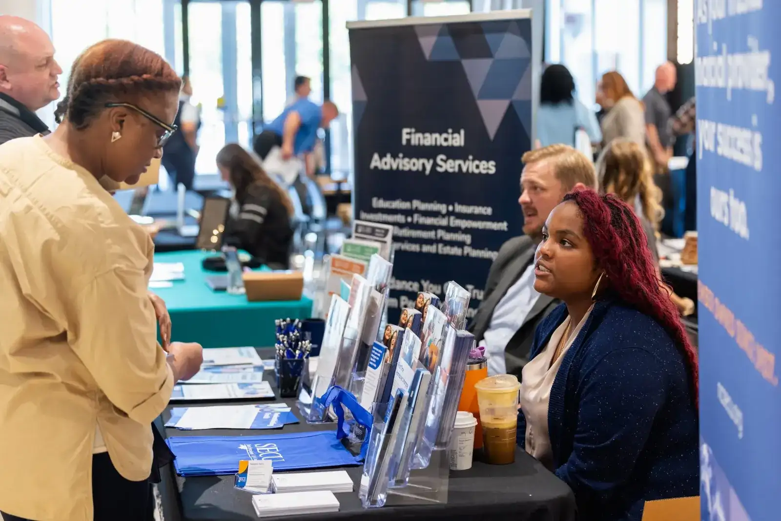 Student talking with staff at a financial advisory services table