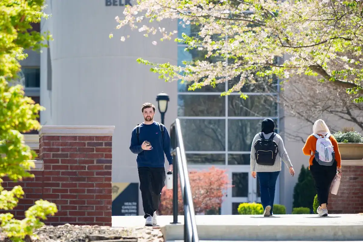 Students walking across campus during spring time