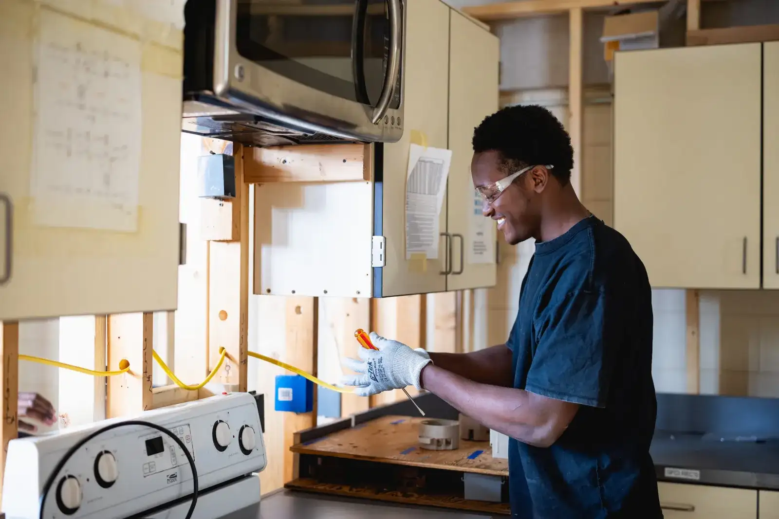 Electrical systems student wiring a panel in an appliance training lab