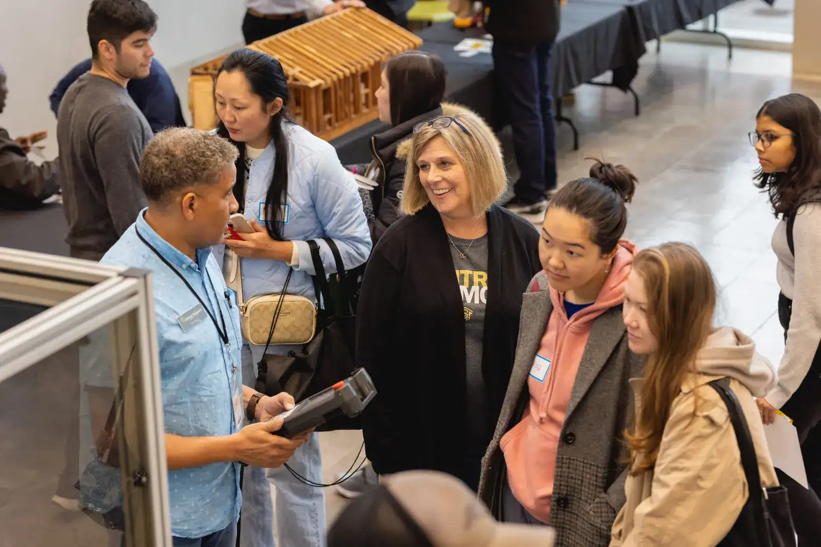 Visitors talking with staff during a campus open house