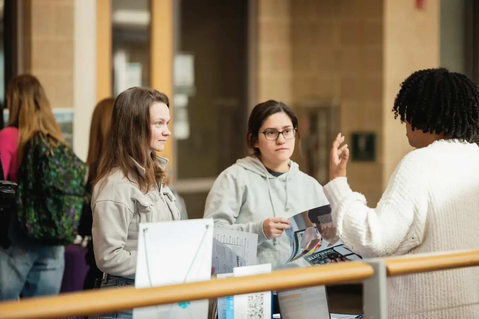 Business students talking together in a campus corridor