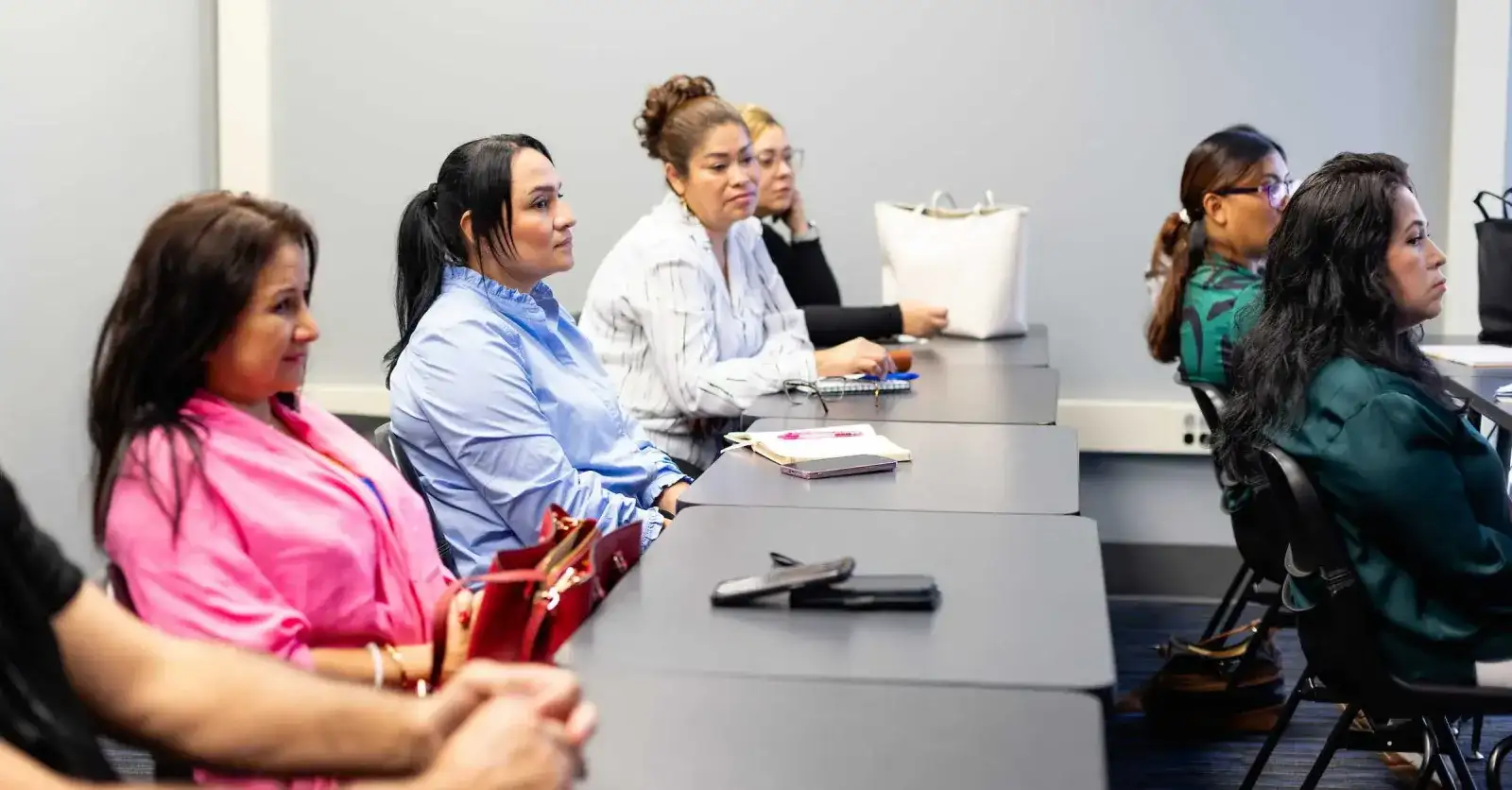 Adults seated at tables during a caseworker training session