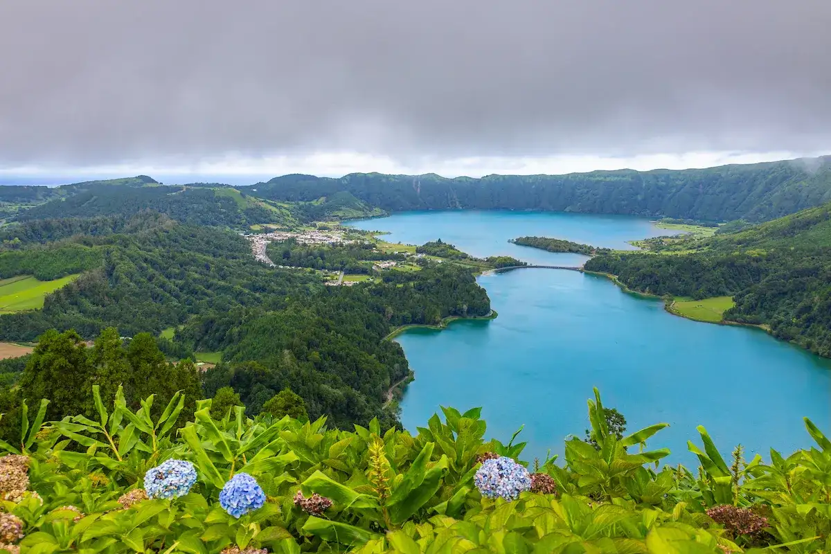 Lush greenery bordering a bright blue body of water seen on a Central Piedmont study abroad trip to Portugal.