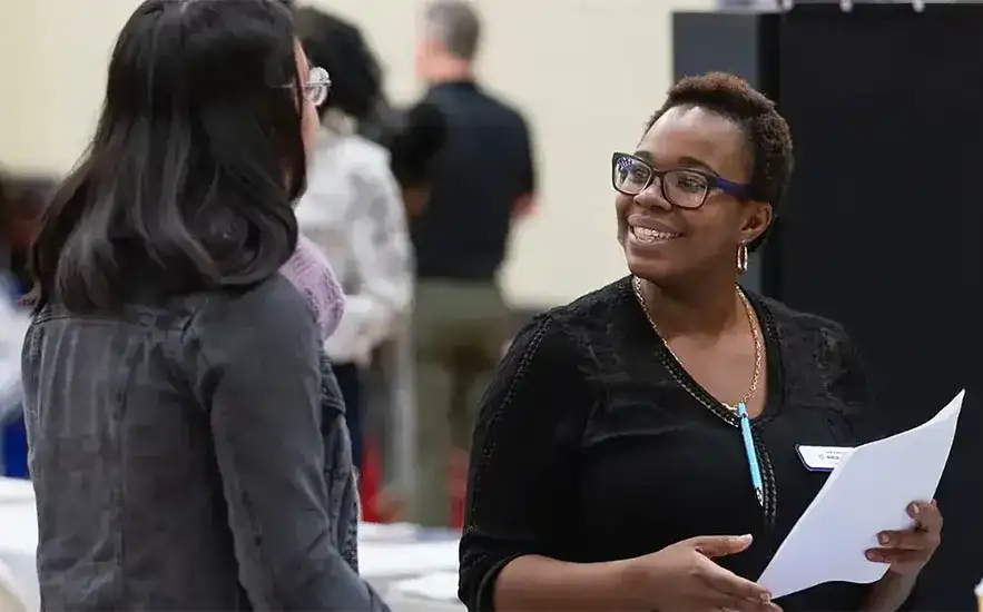 Two individuals interacting at a Central Piedmont event