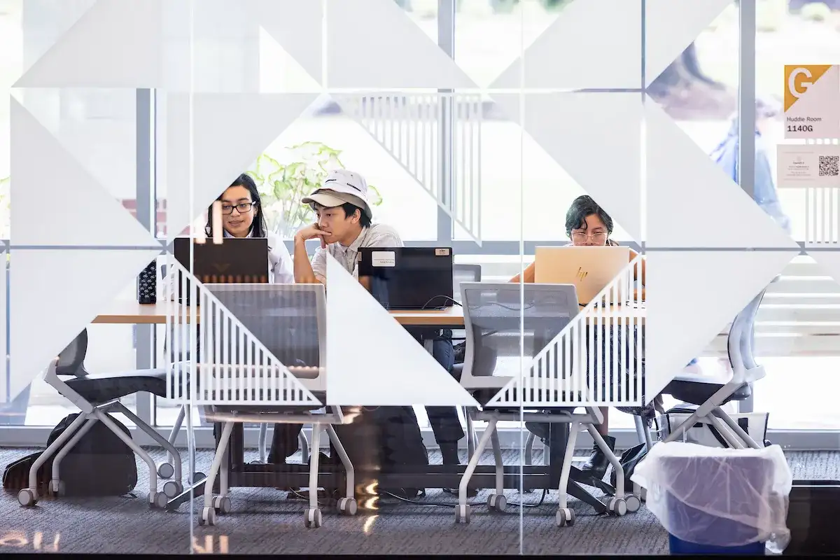 Students seated around a study table in the library