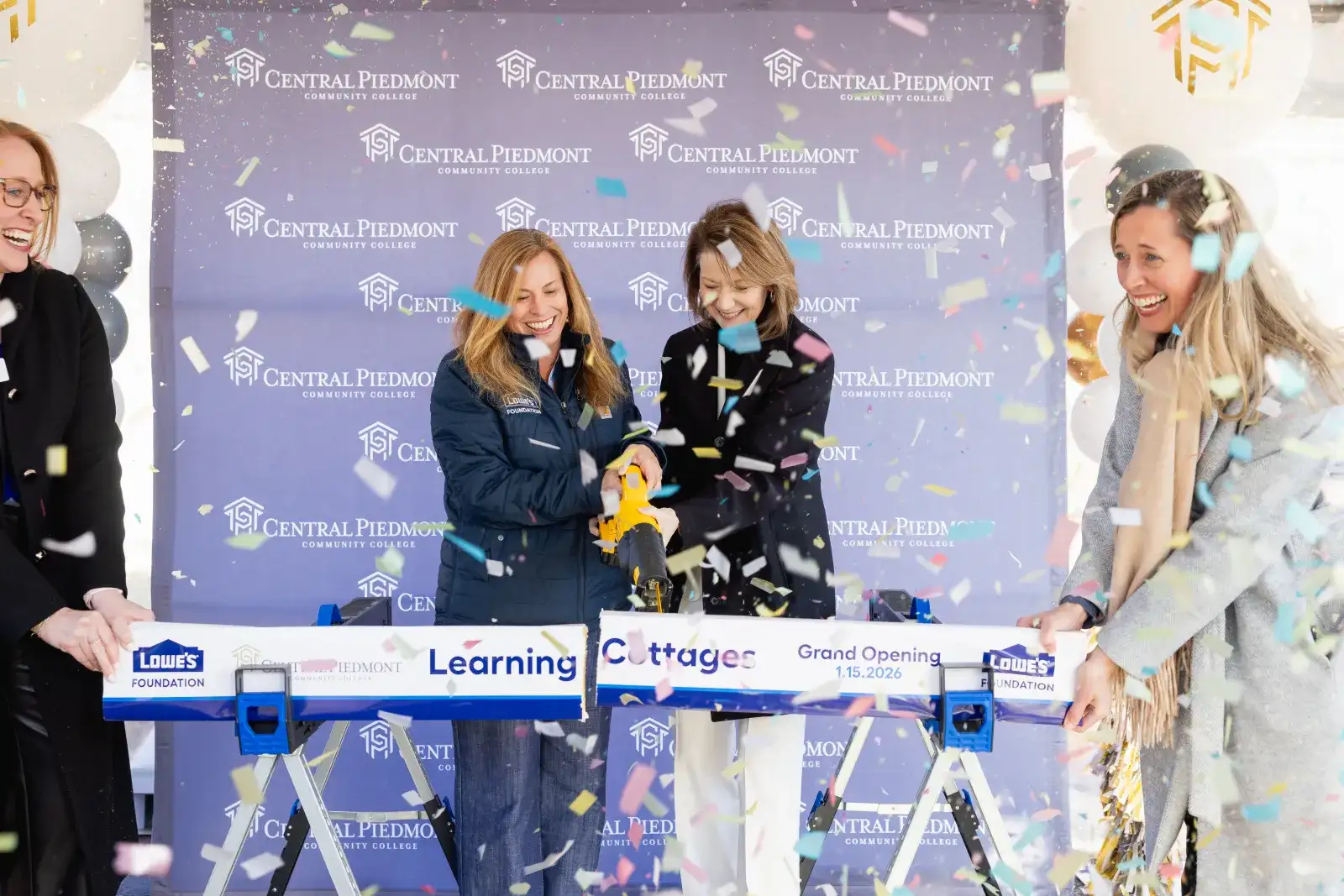 Board cutting ceremony for Lowes learning cottage grand opening