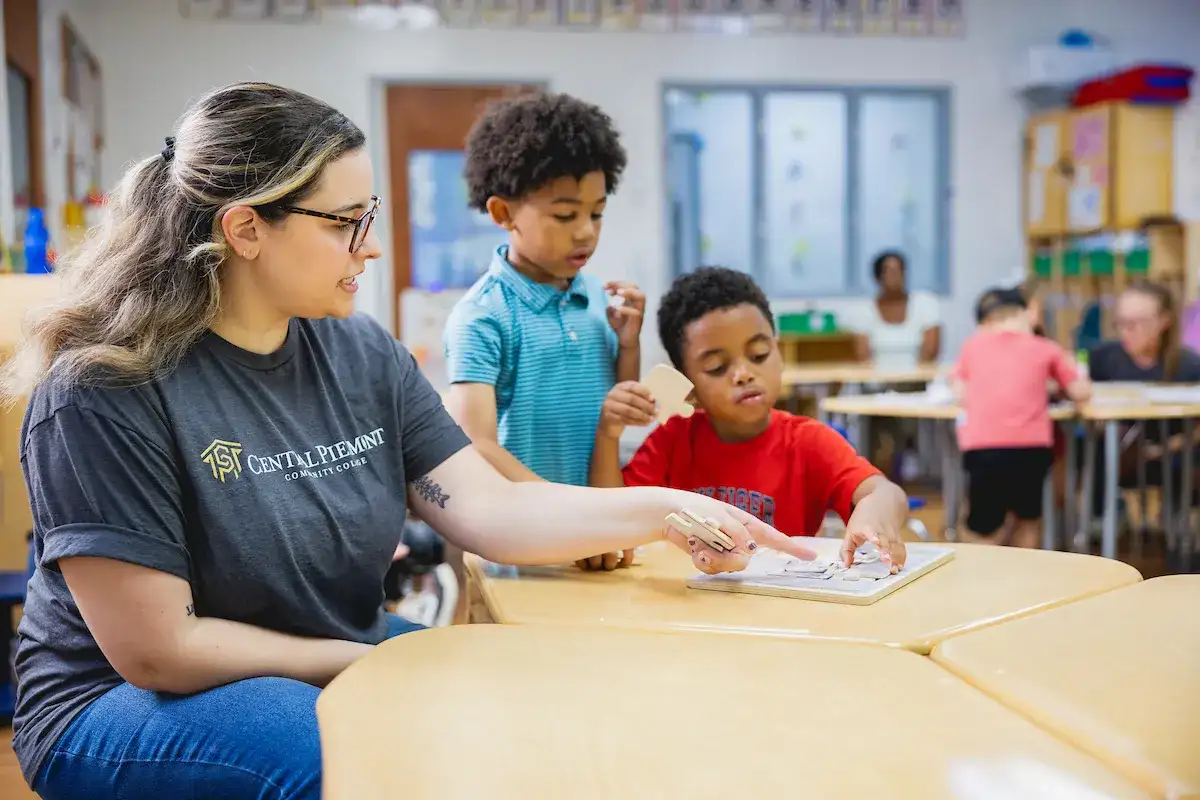 Early Childhood Education program student in a classroom with elementary age students