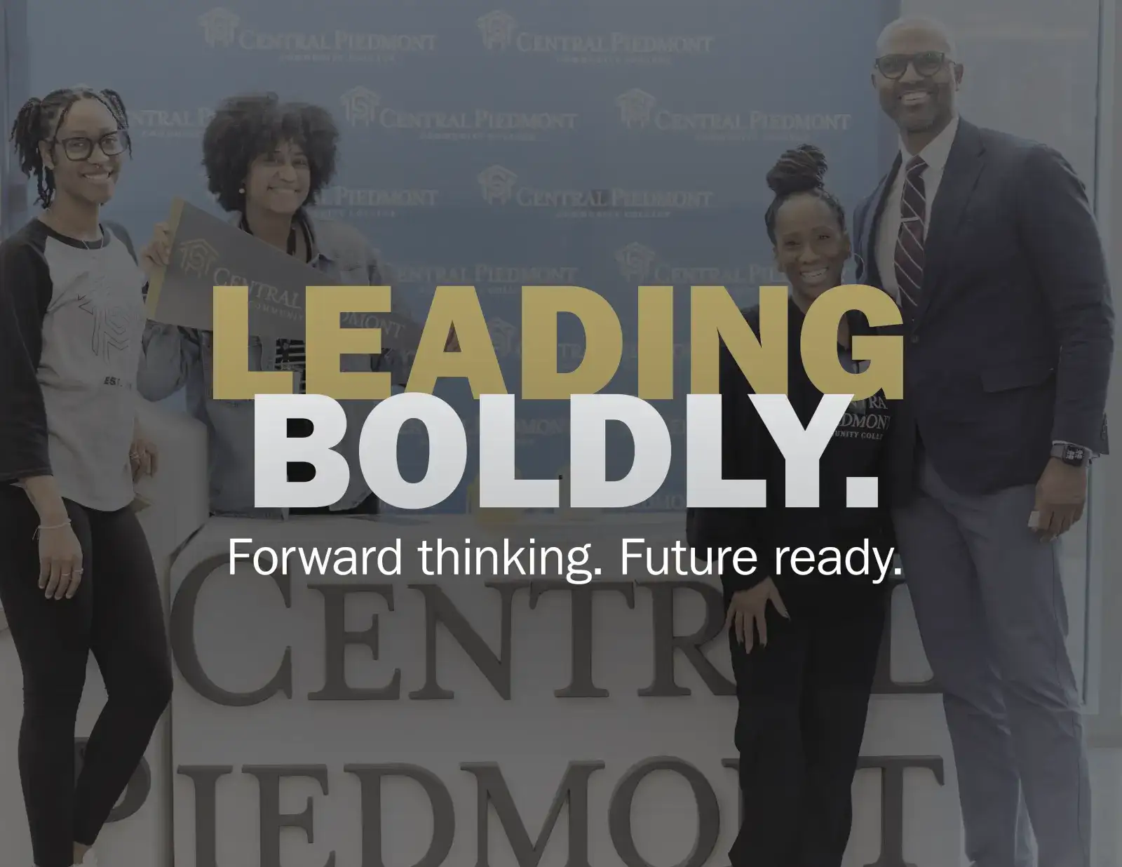 Leading boldly logo over image of students and staff
