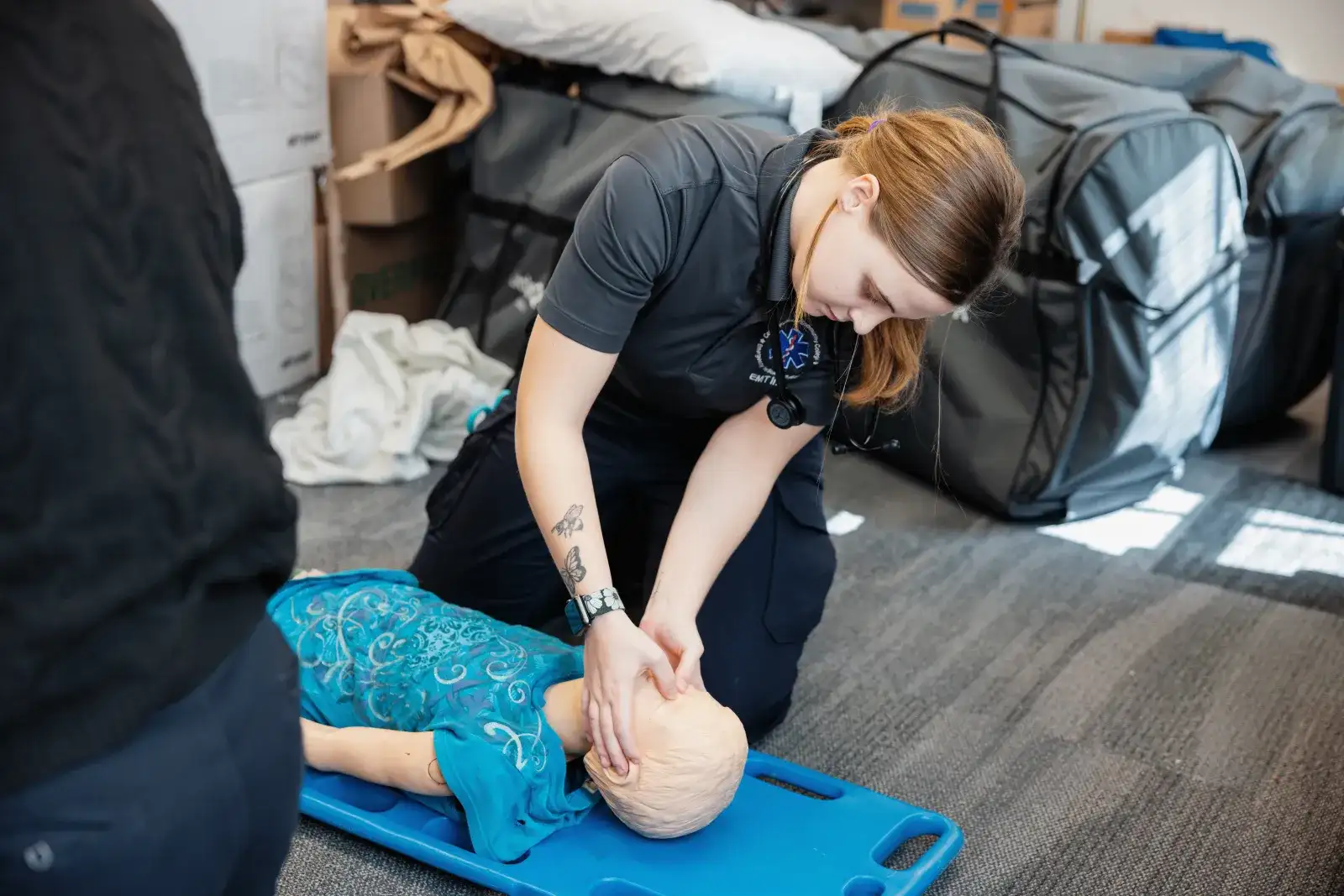 Emergency medical student assessing a training dummy