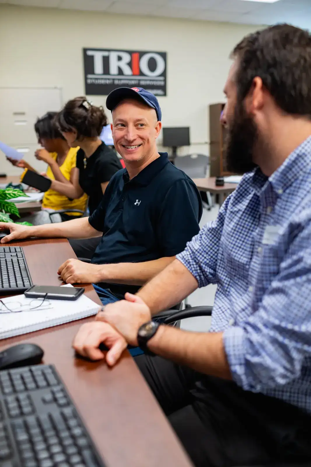 students at a computer smiling