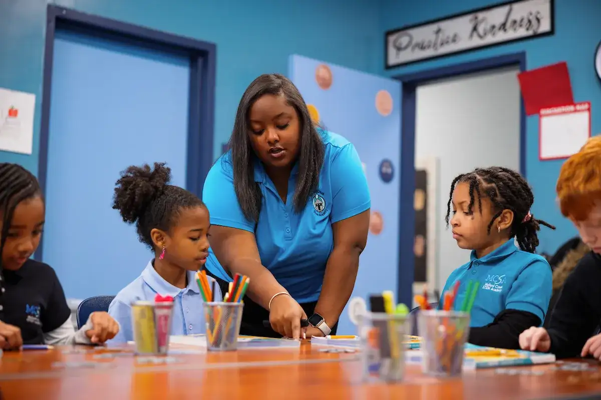 Teacher with elementary age students in a classroom setting