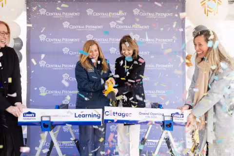 Board cutting ceremony for Lowes learning cottage grand opening