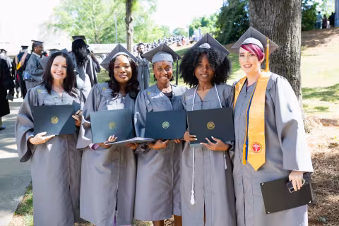 group of central piedmont graduates smiling and posing