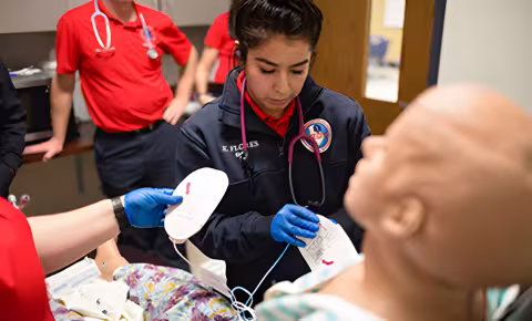 Emergency medical services student treating a patient simulator